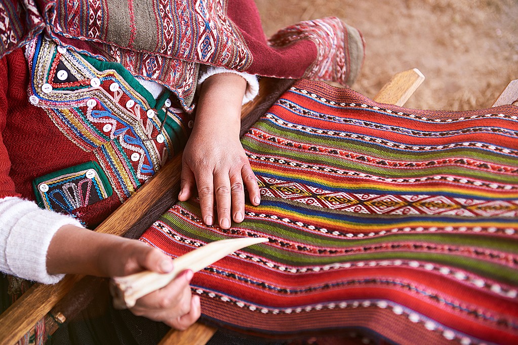 Traditional handmade wool production in Cusco Peru. Colorful alpaca clothing making factory